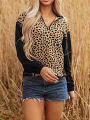 Leopard print zip hoodie with black sleeves and contrast stitching.