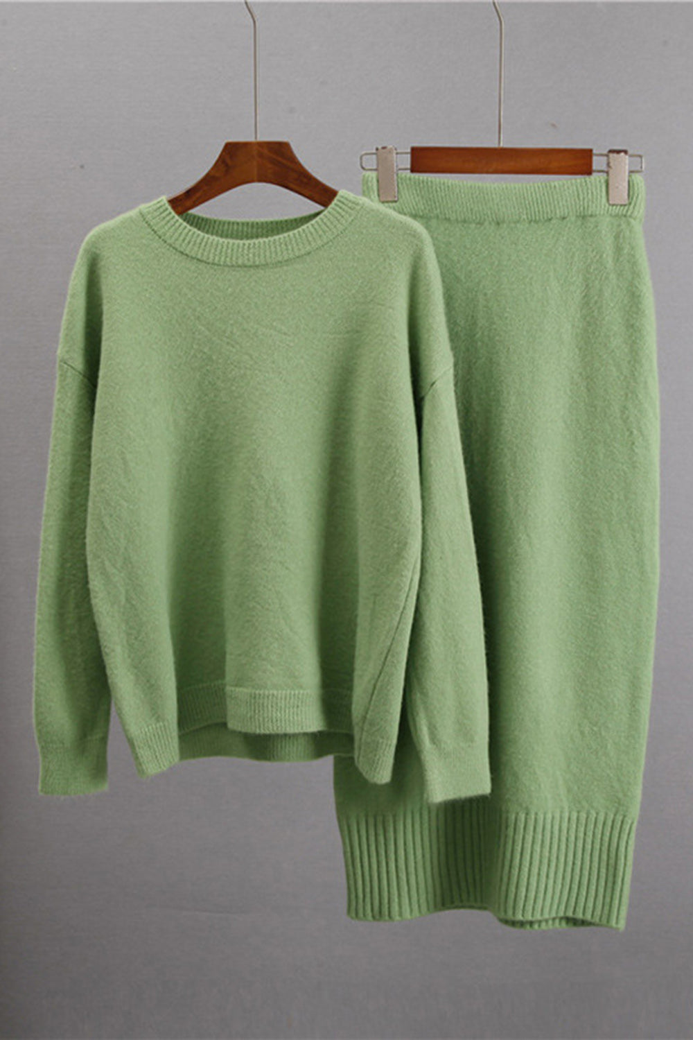 Ribbed knit midi co-ord set in Gum Leaf green, featuring a crewneck sweater and midi skirt.
