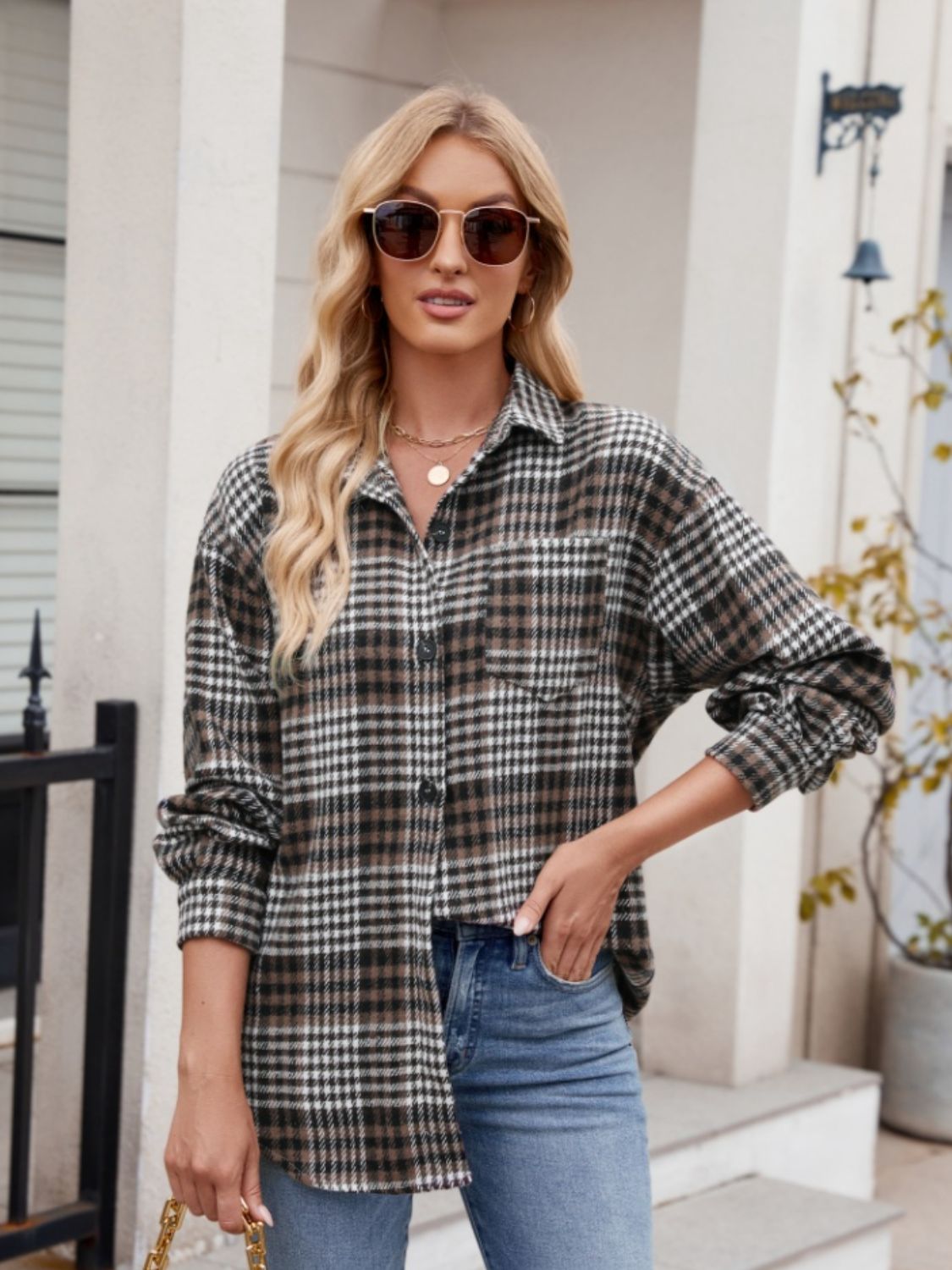 Oversized plaid shirt jacket in brown and black with a chest pocket and button front.
