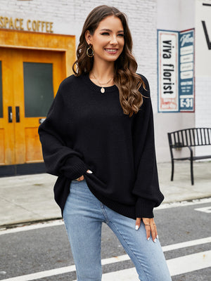 Black acrylic crewneck sweater with balloon sleeves and ribbed cuffs, styled with jeans.