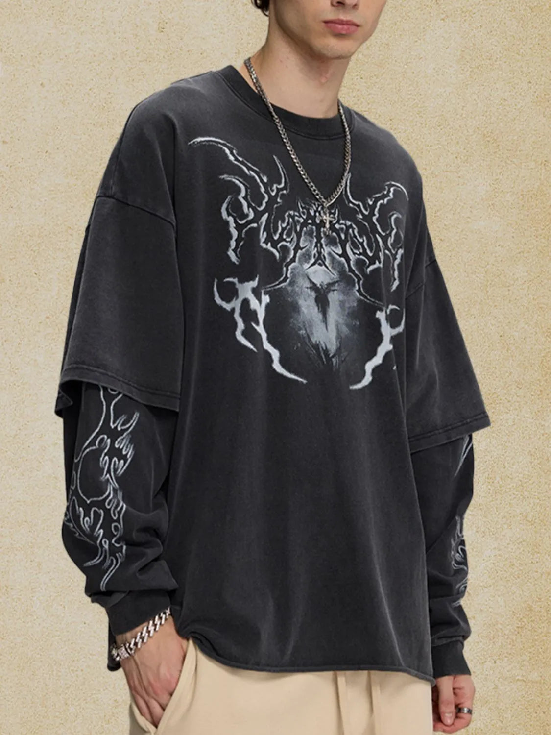 Black layered graphic sweatshirt with distressed effect and flame design on sleeves.