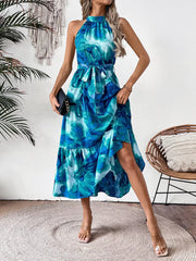 Blue floral halter neck midi dress with tie belt and tiered skirt.