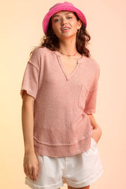 Relaxed pale blush waffle knit v-neck top with short sleeves and a chest pocket.