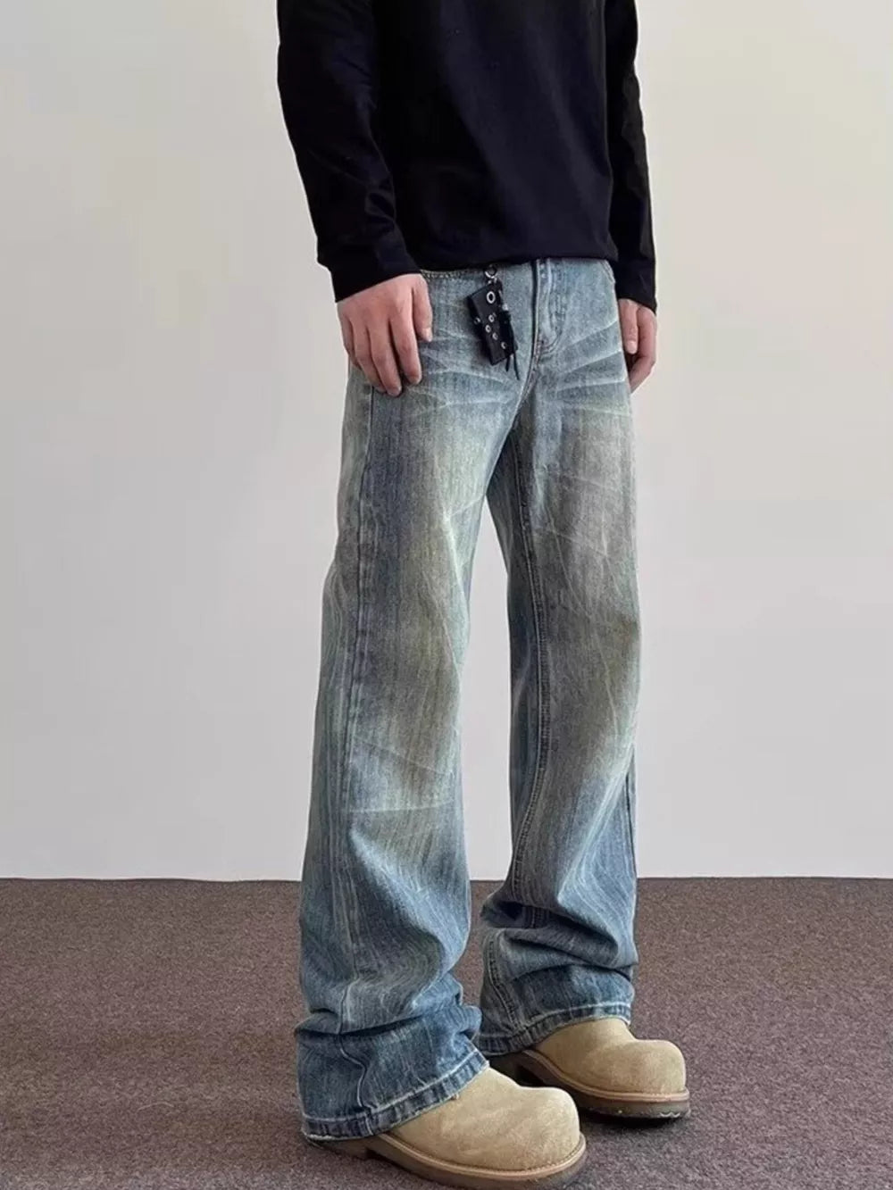 Men's vintage wash wide leg jeans in blue cotton, featuring a relaxed fit and distressed details.