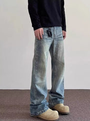 Men's vintage wash wide leg jeans in blue cotton, featuring a relaxed fit and distressed details.