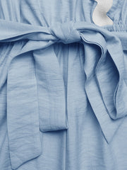 Blue maternity wrap romper with tie waist and scalloped trim detail.