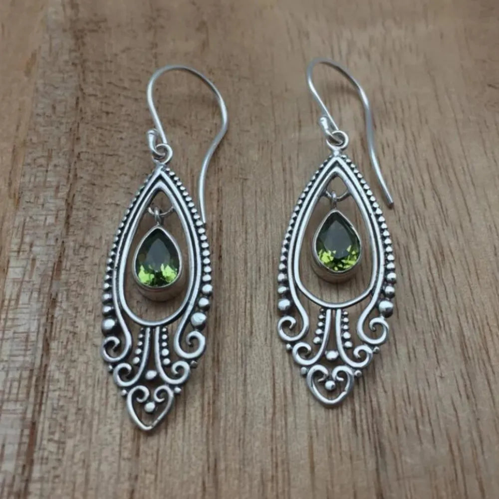 Silver filigree drop earrings with pear-shaped peridot stones