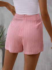 Blush pink textured wrap skort with tie detail and a zipper closure.