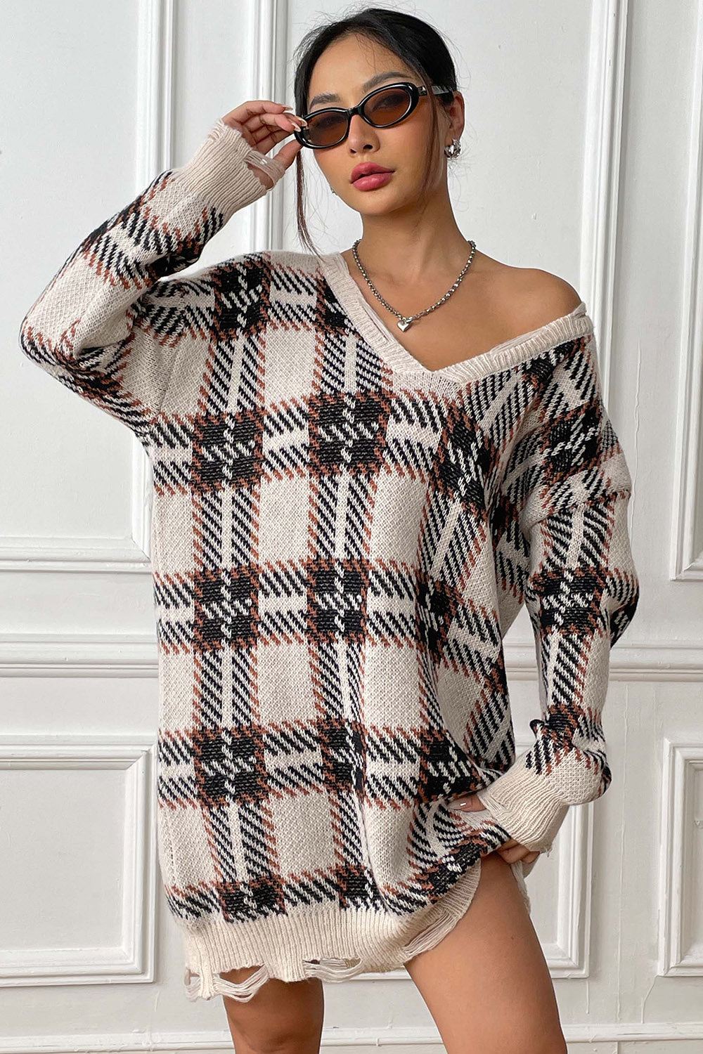 Plaid knit mini dress with distressed hem and V-neck.