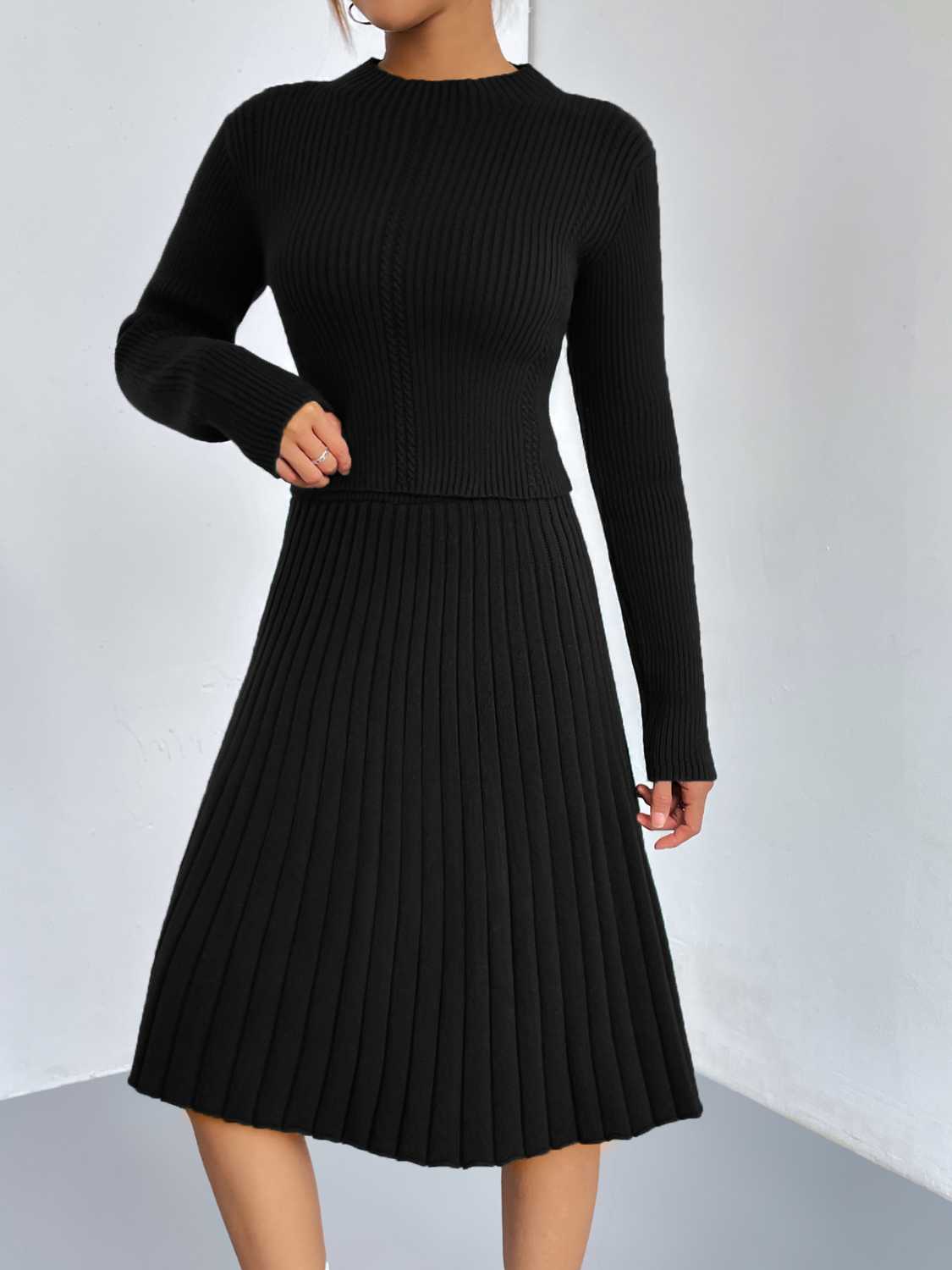 Black ribbed knit fit-and-flare co-ord set with long sleeves and A-line skirt.