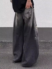 Men's dark wash wide leg distressed jeans with a relaxed fit.