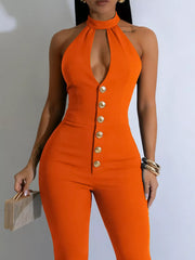Orange halter cut-out jumpsuit with gold buttons and a high neckline.