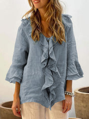 Light Blue linen blouse with ruffled neckline and flared sleeves.