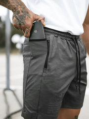 Dark Gray Tech-Knit Utility Pocket Shorts with zipper pocket detail and drawstring waist.