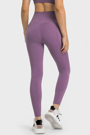Purple performance leggings with sculpted waistband and pockets, shown from the back.