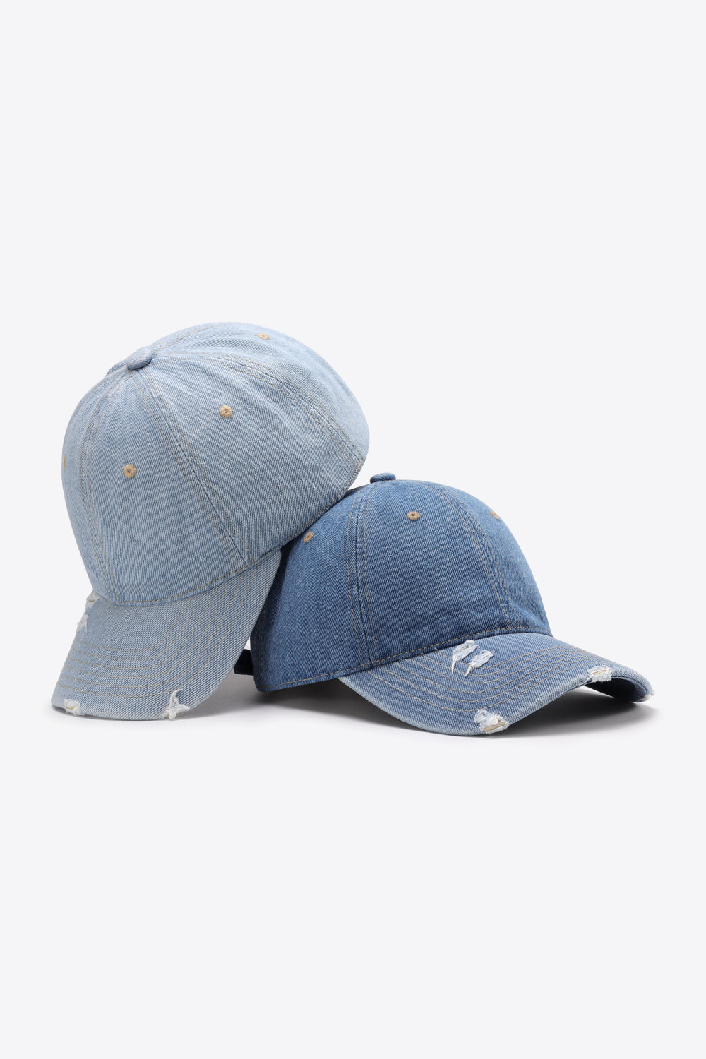 Distressed denim baseball caps in light and medium blue with adjustable strap