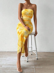 Yellow tie-dye ruched strapless midi dress with a thigh-high slit.