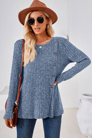 Dusty blue ribbed knit sweater with asymmetric button detail and long sleeves.