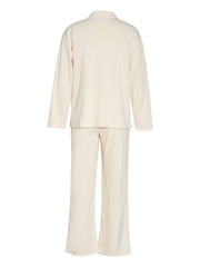 Cream ribbed knit lounge set with relaxed fit long sleeve top and wide leg pants.