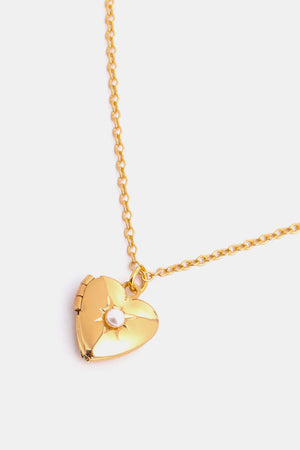 Gold heart locket necklace with pearl detail and chain.