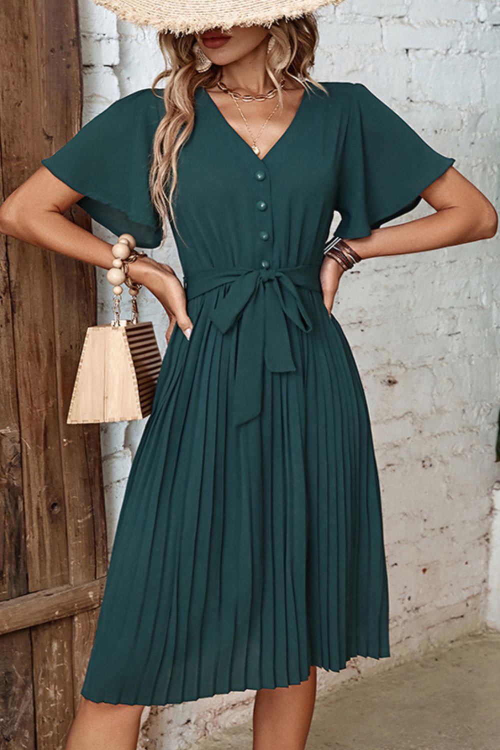 Forest green midi dress with flutter sleeves, V-neck, buttons, and pleated skirt.