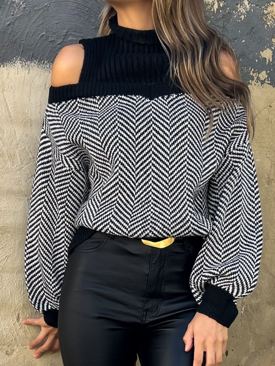 Black chevron knit sweater with cutout shoulders and a mock neck.