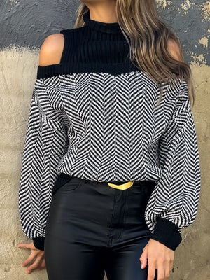 Black chevron knit sweater with cutout shoulders and a mock neck.
