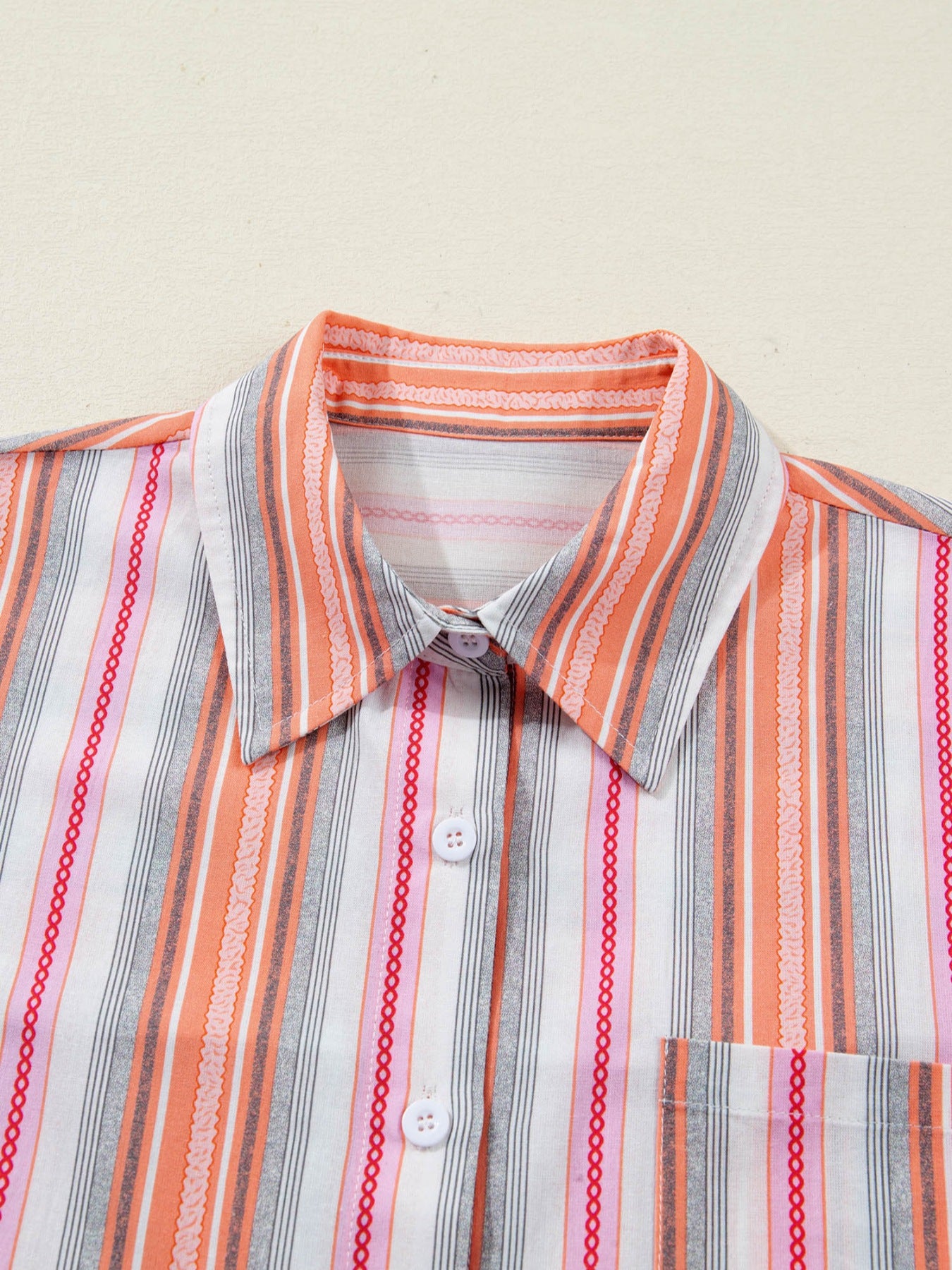 Classic button-down shirt with orange, pink, and gray stripes, cotton, short sleeves, collar, and pocket.