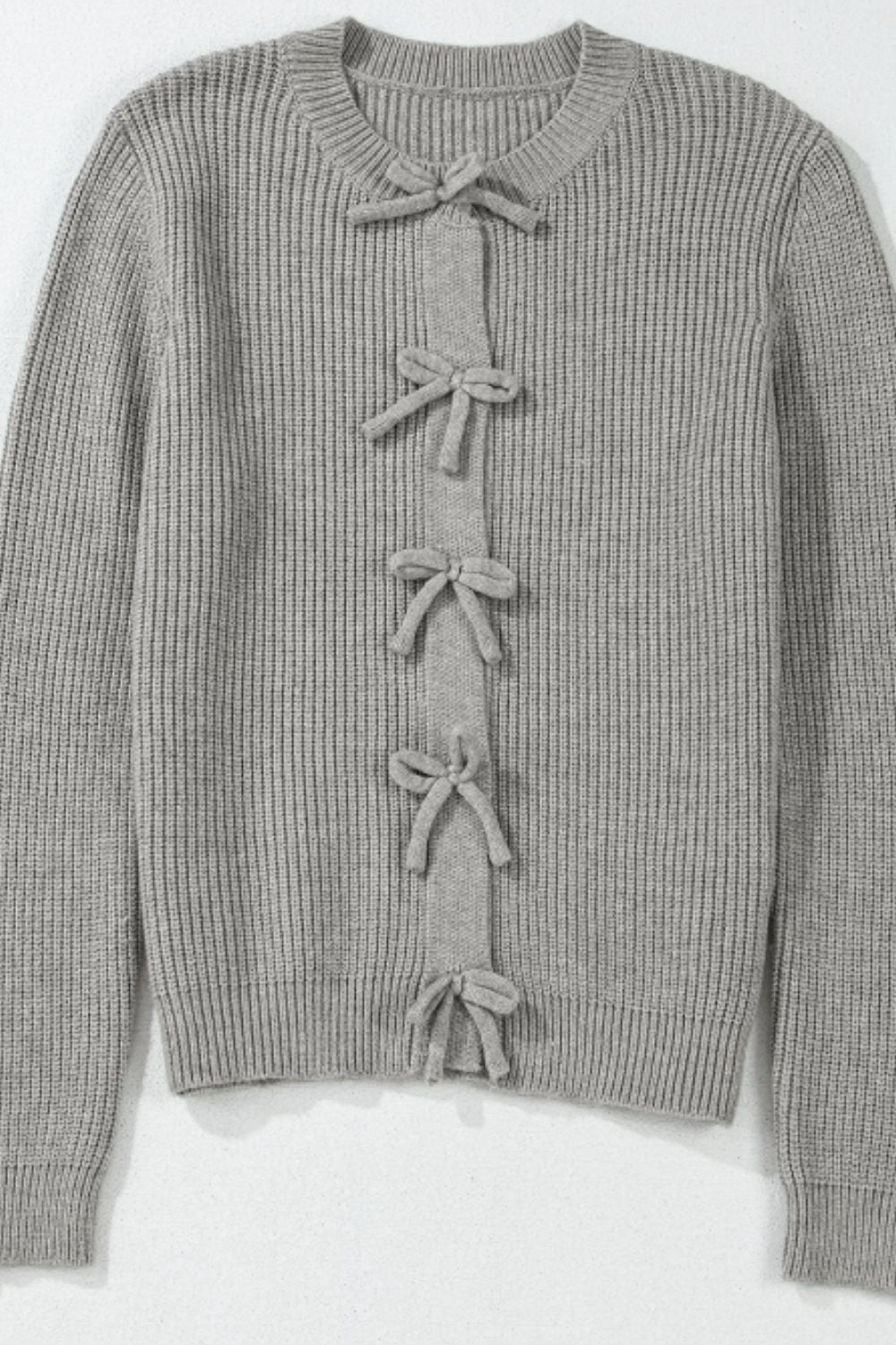 Gray ribbed knit cardigan with a tie-front detail and bow accents.