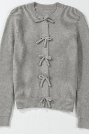 Gray ribbed knit cardigan with a tie-front detail and bow accents.