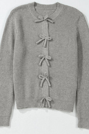 Gray ribbed knit cardigan with a tie-front detail and bow accents.