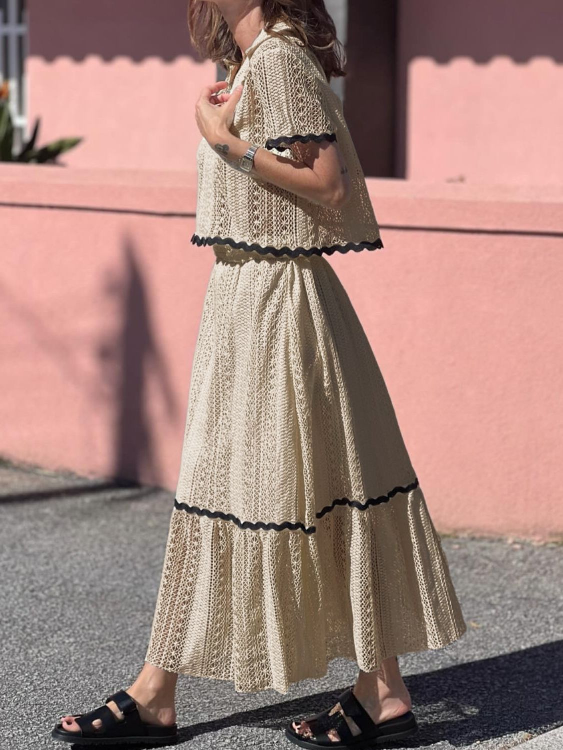 Cream crochet co-ord set with scalloped black trim, featuring a cropped top and maxi skirt.