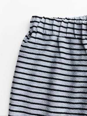 Chic striped crop top and wide-leg set in black and off-white textured fabric with elastic waistband.