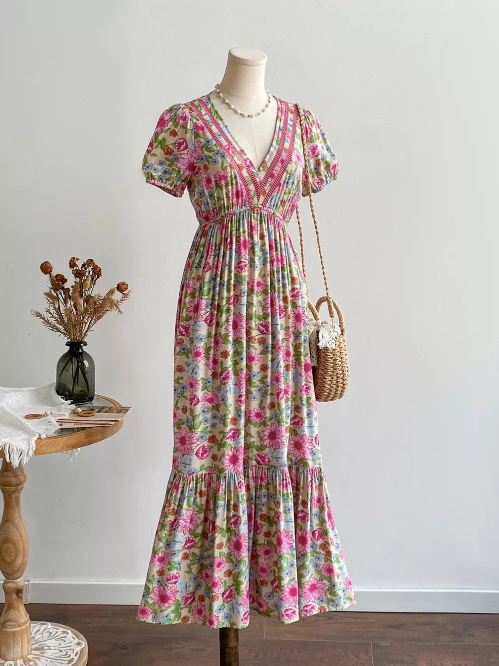 Maxi dress with short sleeves, V-neck, and tiered skirt in a floral print with decorative trim.