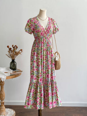 Maxi dress with short sleeves, V-neck, and tiered skirt in a floral print with decorative trim.
