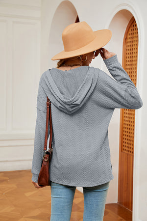 Textured grey hoodie with drop shoulder and hood, casual knit top.