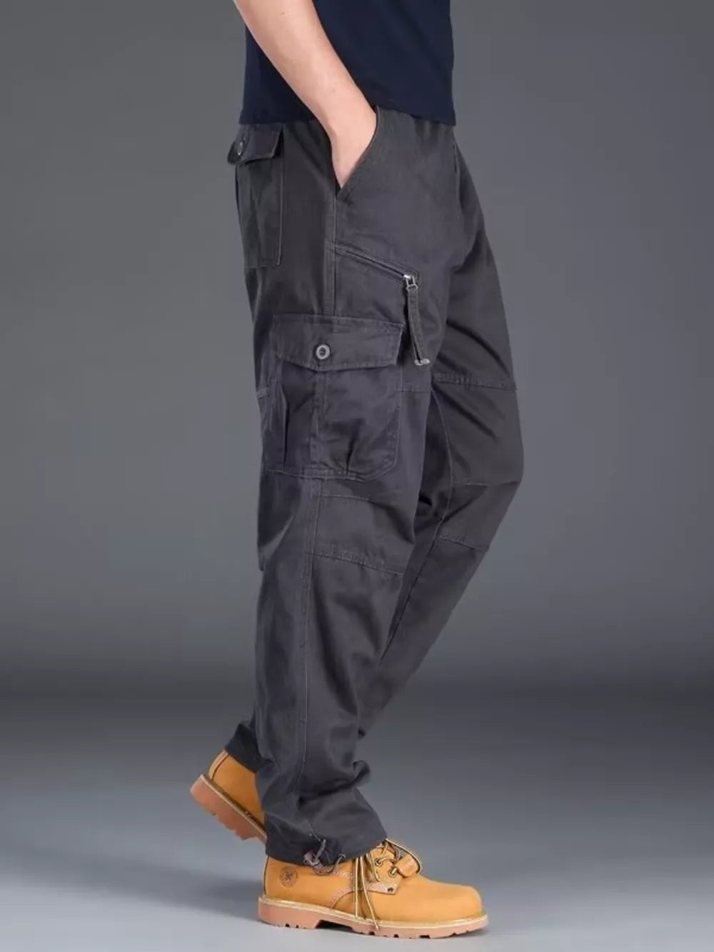 Men's gray cargo pants with multiple pockets and zipper detail.
