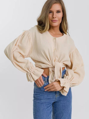 Ochre textured puff sleeve blouse with tie front and ruffled cuffs.