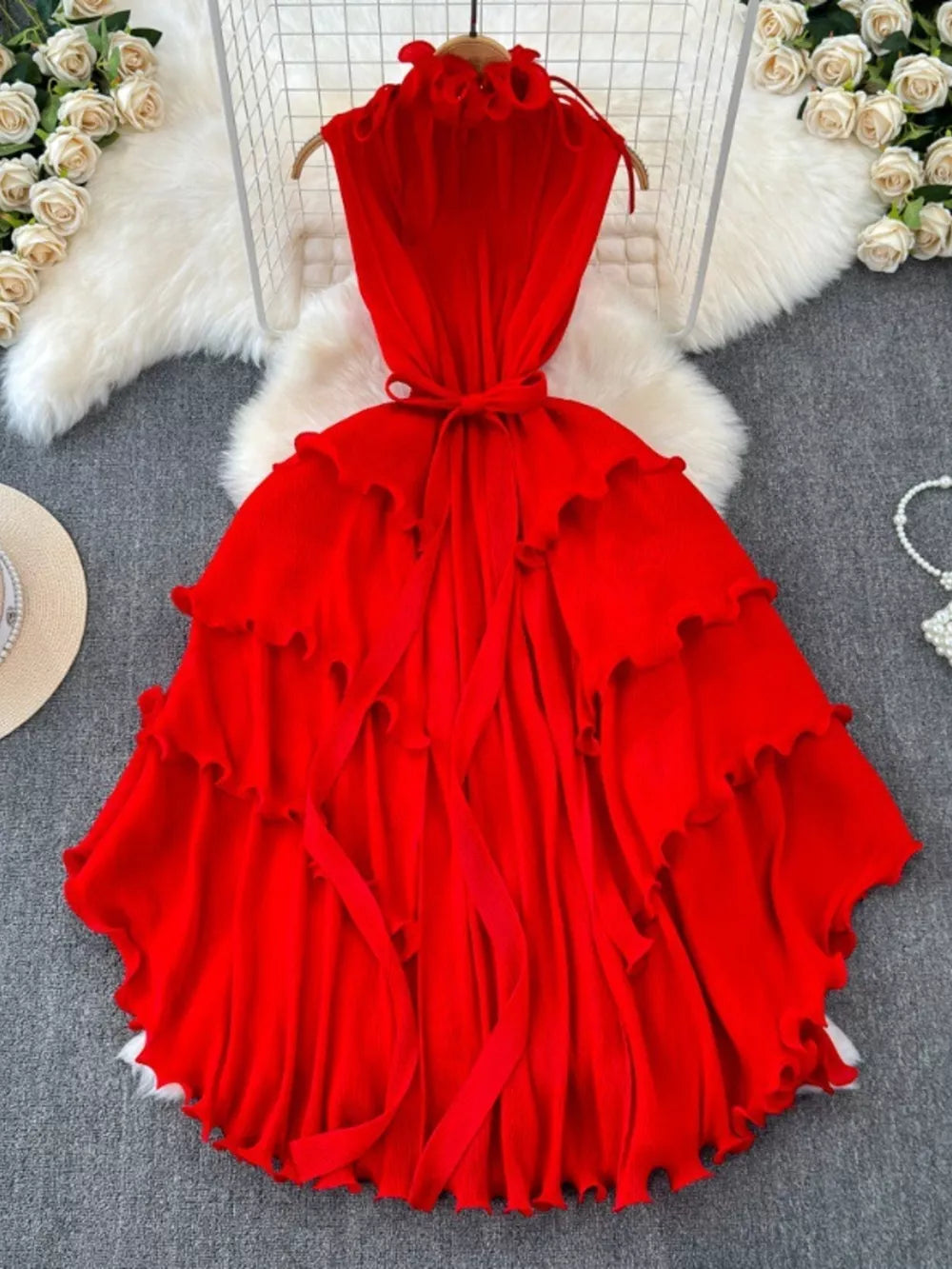 Ruffled tiered midi dress in rose red with belted waist and frill details.