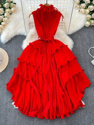 Ruffled tiered midi dress in rose red with belted waist and frill details.