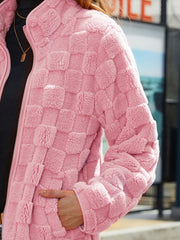 Blush pink textured grid zip-up jacket with a stand-up collar.