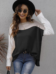 Colorblock crewneck knit sweater in black and cream with side slits.