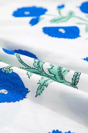 White cotton blouse with blue floral print and green leaves
