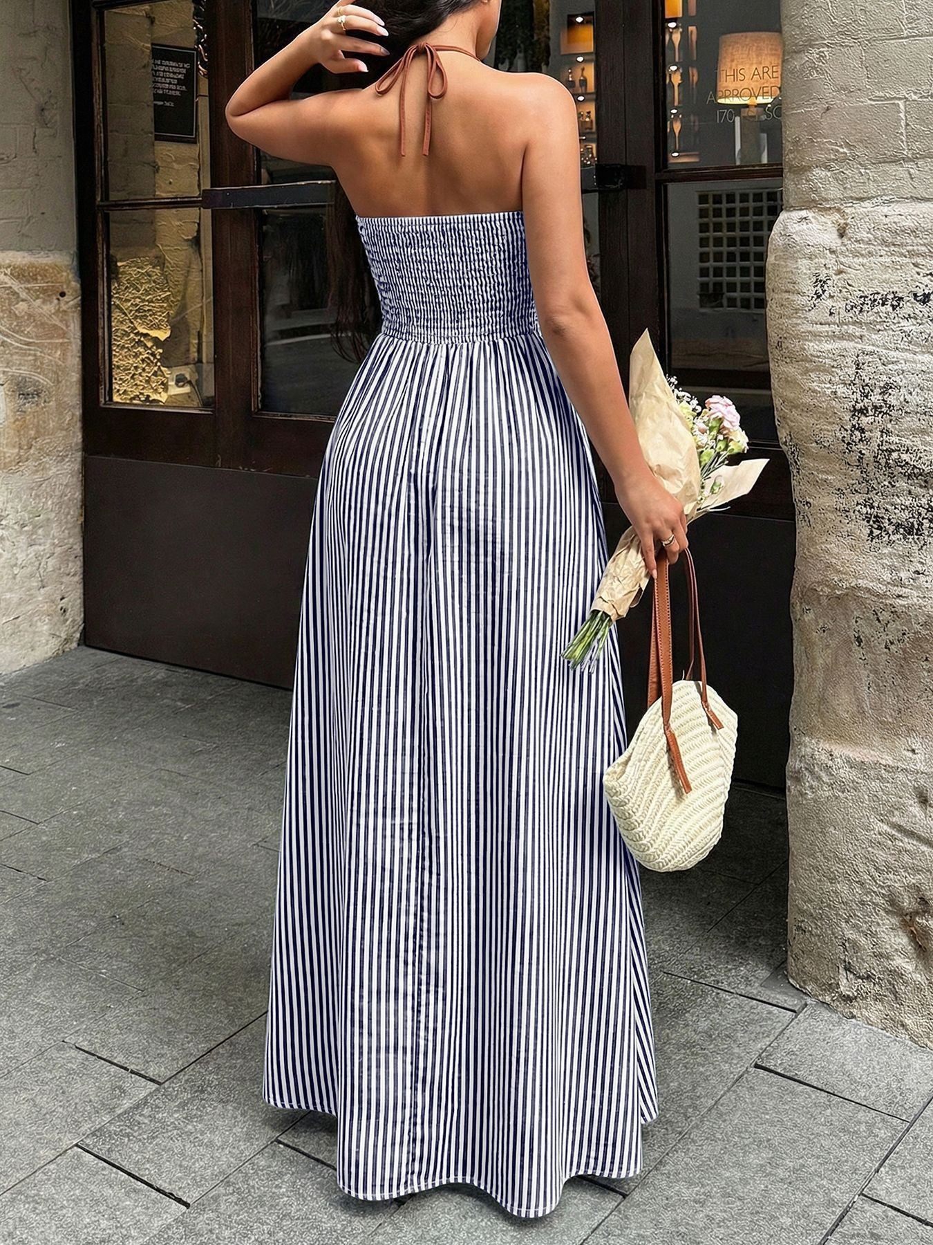 Striped maxi dress with halter neckline and smocked bodice, in dark blue and white.