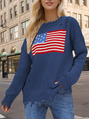 French blue knit sweater with distressed details and an American flag graphic.
