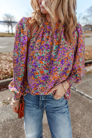 Purple floral print blouse with gathered sleeves and mock neck
