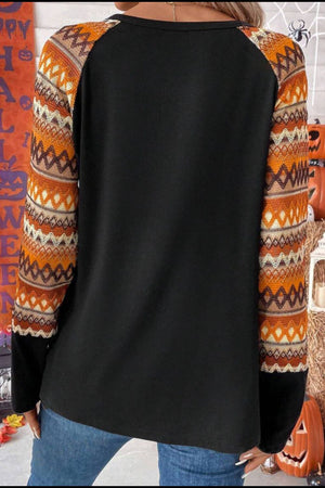 Black raglan tee with Aztec print sleeves in orange and tan.