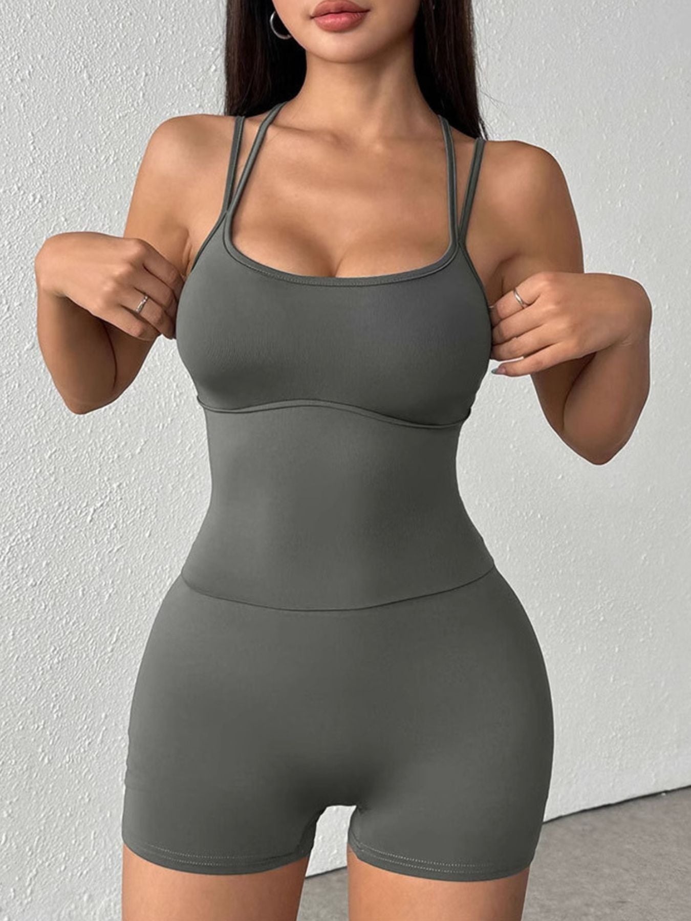 Grey scoop neck active romper with spaghetti straps and short legs, made of cotton blend.
