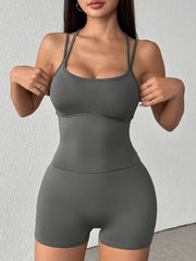Grey scoop neck active romper with spaghetti straps and short legs, made of cotton blend.