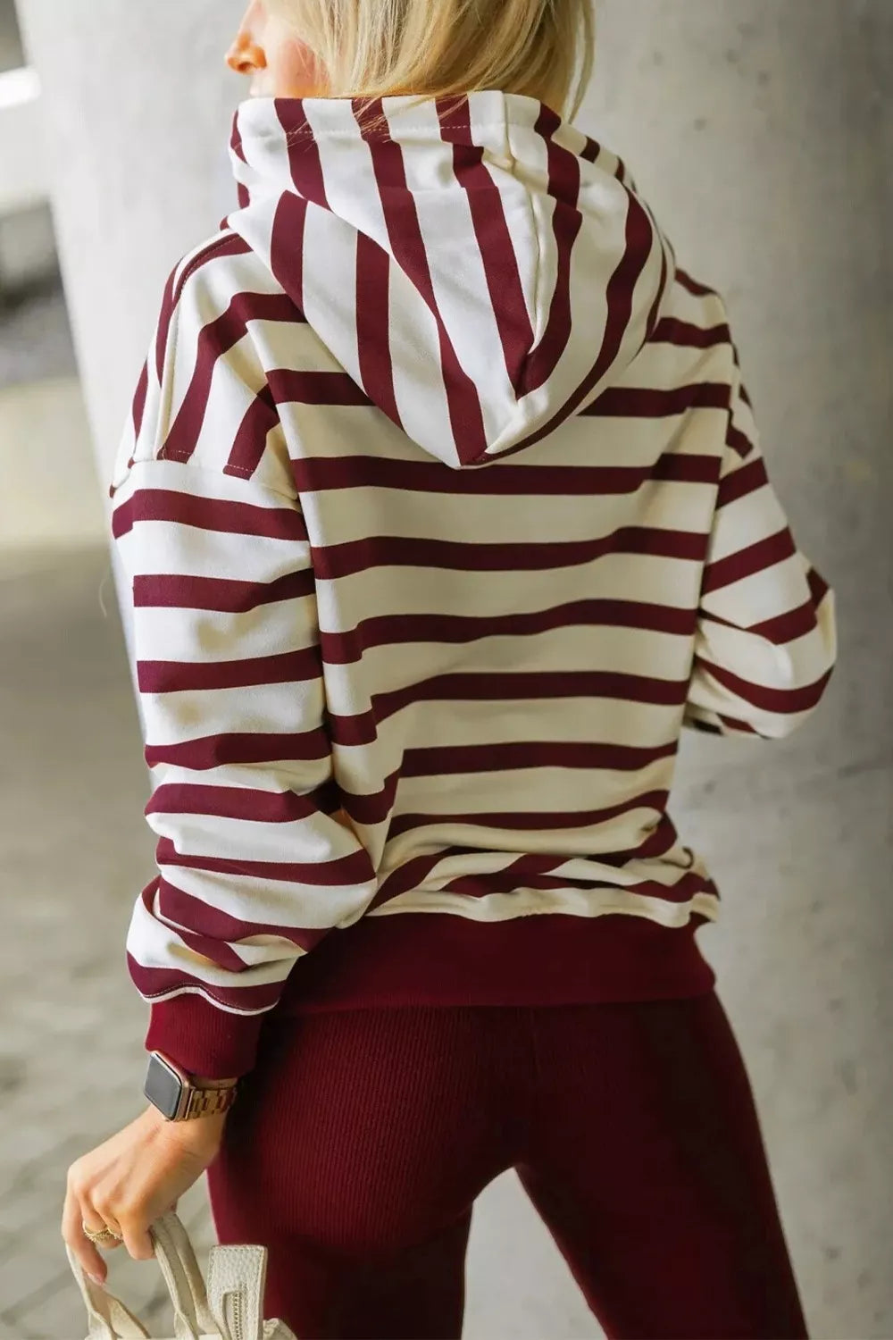Striped hoodie lounge set with burgundy leggings.